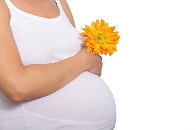 Pregnant woman holding her stomach. Acupuncture may ease some of the strains and stresses of pregnancy. Try Worcester Acupuncture